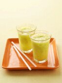 Two glasses of honeydew melon and pineapple juice