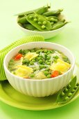 Green minestrone with peas and ravioli