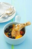 Chicken leg with tomatoes, olives, oranges and saffron