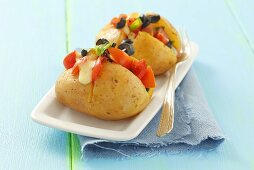 Baked potatoes with tomato and olive salad