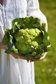 Woman holding green cauliflower