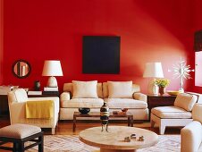 Dark blue artwork on red wall in interior with pale furniture