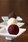 A rum truffle with a chocolate crust, a champagne truffle and a chocolate truffle with a cassis crust