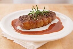 A steak with rosemary and gravy