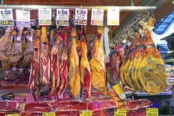 Various types of ham on a market stall (Mercat de St. Josep (Boqueria), Las Ramblas, Barcelona, Spain)