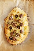 Mushroom and Pecorino pizza on baking parchment