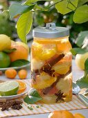 Bottled citrus fruit with cinnamon sticks and star anise