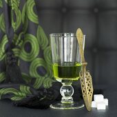 Glass of absinthe, spoon and sugar cubes
