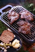 Pork neck steaks on a barbecue