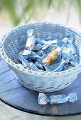 Almond caramels in a pale blue basket