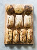 Assorted bread rolls on chopping board