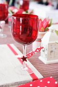 Rotes Weinglas auf einem Weihnachtstisch