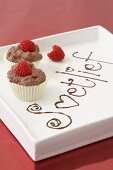 Chocolate mousse cupcakes decorated with raspberries