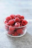 Frozen raspberries in glass dish