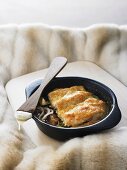 Turkey escalopes with gratin topping on aubergines and courgettes