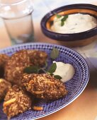 Deep-fried meatballs with couscous, with yoghurt dip
