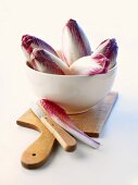 Red chicory in a bowl and on board