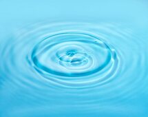 Drops falling into water and making circular ripples
