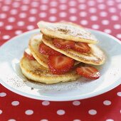 A pile of pancakes with strawberries