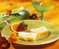 Two slices of orange parfait on dessert plate