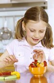 Girl with fresh vegetable sticks