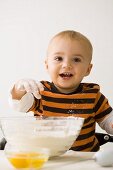 Small boy with bowl of flour