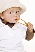 Small boy eating salted sticks