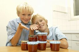 Two blond boys with home-made strawberry jam