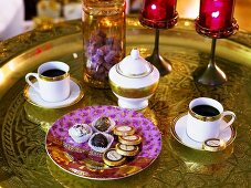 Chocolates and coffee on golden tray