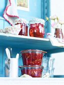 Rose jelly and plum chutney in preserving glasses