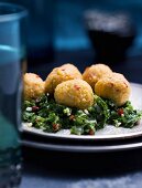 Lentil balls on a bed of herbs