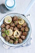 Meat balls with lemon in a pan