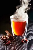 A steaming glass of spiced tea
