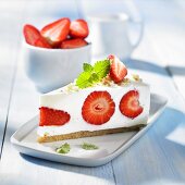 A slice of cream cheese cake with strawberries