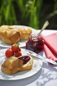 A bread roll with strawberry jam