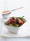 Lemon chicken with tomatoes, capers, beans and olives