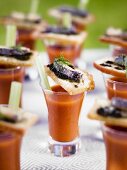 Vegetable soup in schnapps glasses with bread canapes