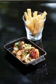 Fried prawns with herbs and dried chilli peppers and toasted bread sticks