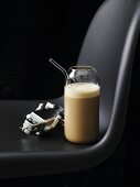 Coffee milkshake in a glass with a straw
