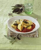 Potato dumplings on tomato sauce with sage and Parmesan