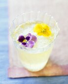 Champagne cocktail with lemon and edible flowers