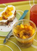 Pumpkin and physalis jam with pecans, in jar and on bread
