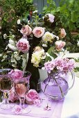 White wine and summer flowers on a garden table