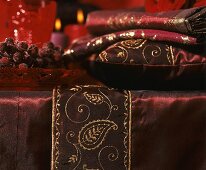 Red Christmas decorations, cushion and fabrics on table