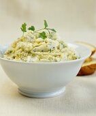 A bowl of mashed potato with coriander and olive oil