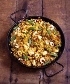 Paella with chicken and shrimps in pan