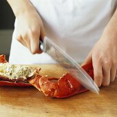 Breaking open the claws of a lobster with the back of a knife
