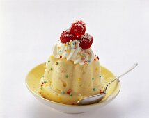 Semolina pudding with whipped cream, raspberries and colourful sprinkles