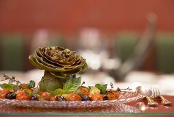 Artichokes with tomatoes, olives, capers and basil