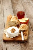 Camembert with nuts, baguette, apple and rose wine